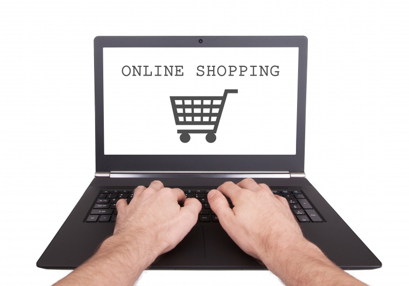 10584618-man-working-on-laptop-online-shopping
